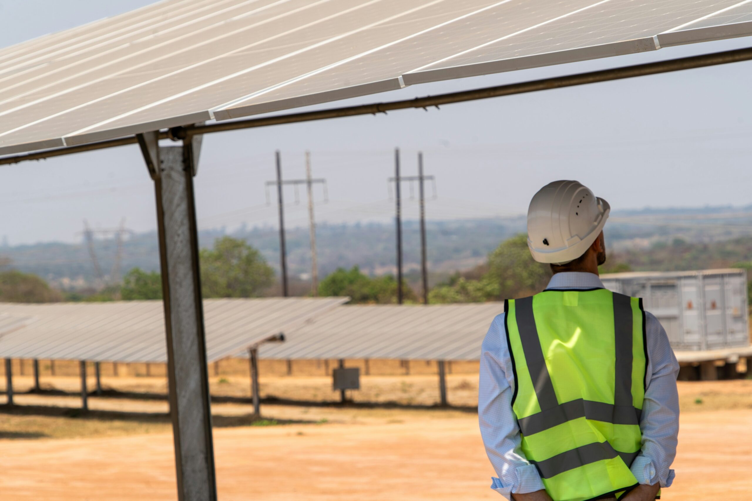 Engineer inspecting rooftop solar panels, illustrating California's new solar permitting savings law