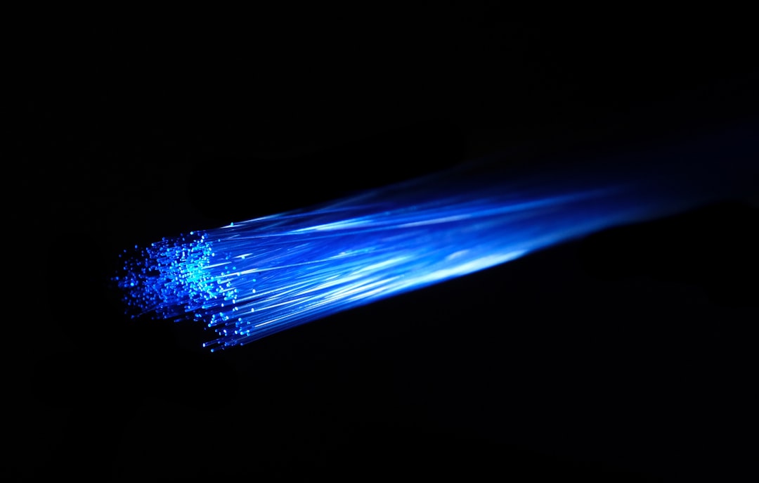 Glowing fiber optic cables representing the Eastern Ohio broadband expansion reaching rural homes.