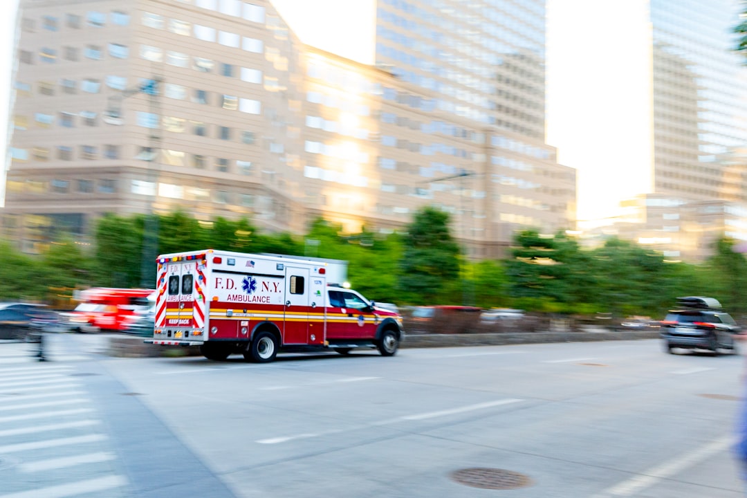 Ambulance responding through a city street, reflecting Frisco digital twin technology speeding emergency response