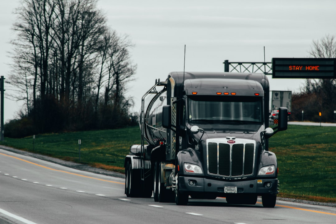 White delivery truck on the highway, similar to Gatik driverless trucks that move groceries without a driver