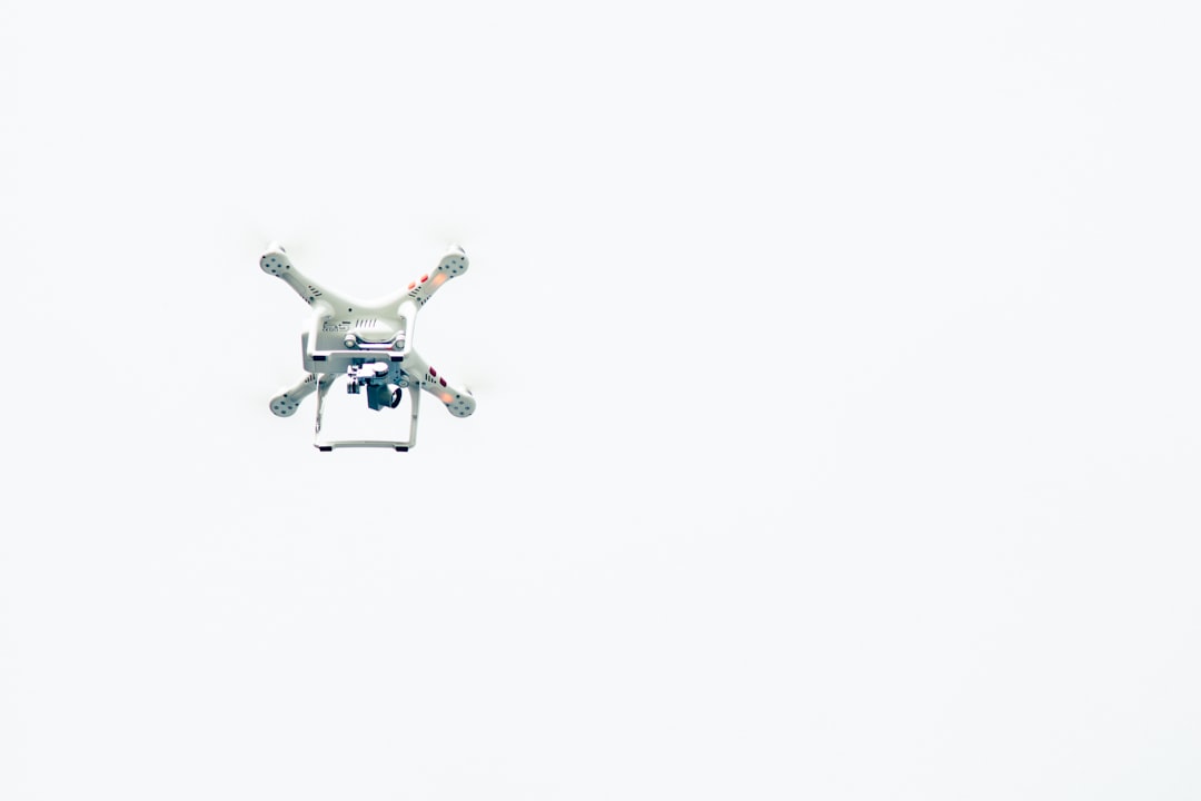 Small autonomous delivery drone in flight, symbolizing Uber Zipline drone delivery for faster neighborhood deliveries