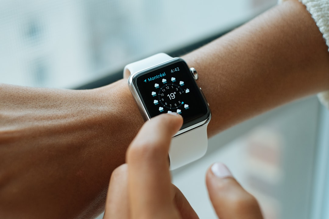 Person checking Apple Watch Audio Intelligence sound alerts outdoors