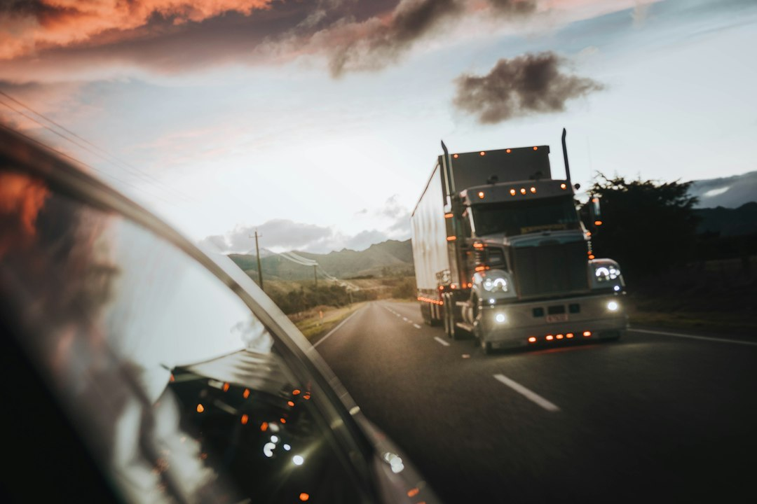 A semi truck driving a highway at dusk, similar to routes Aurora driverless trucks run today