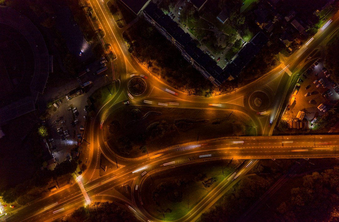 Aerial night view of a busy highway interchange representing Busan's AI traffic signals system