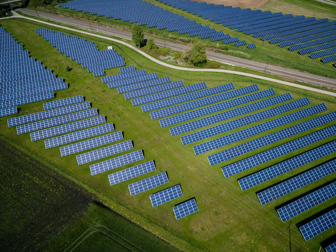 Aerial view of solar panels in a green field, part of the clean energy growth behind Bronx battery storage