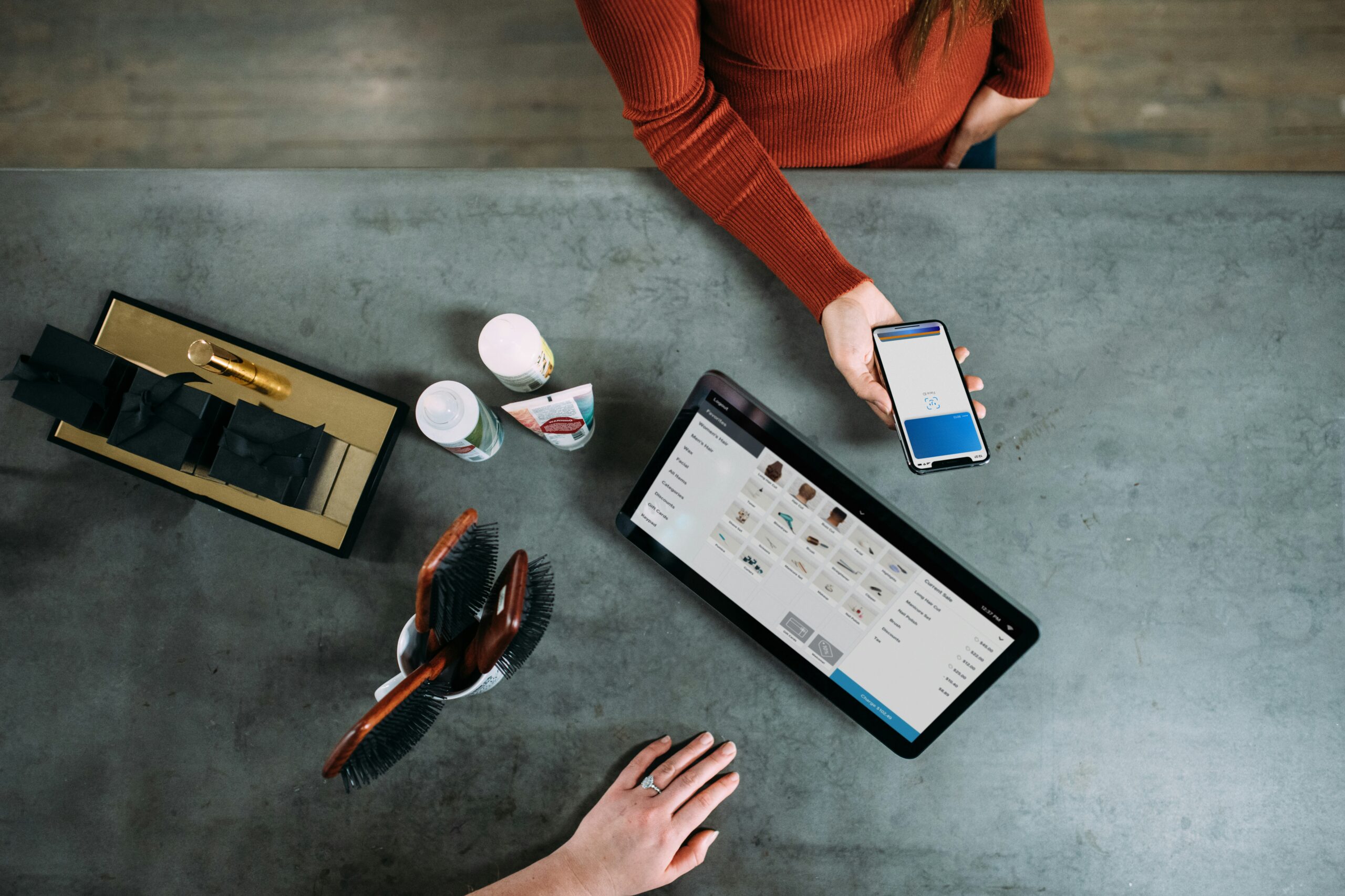 Small business owner processing a mobile payment, illustrating community bank stablecoin payments