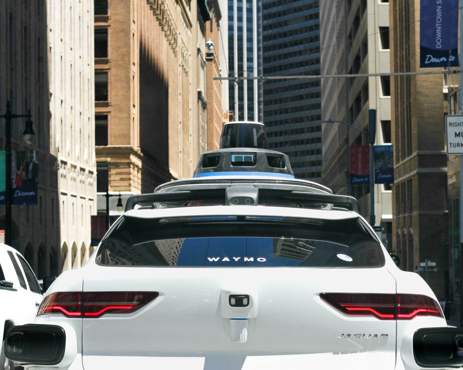 DiDi driverless robotaxi navigating a city street with no driver behind the wheel