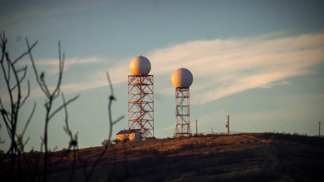 Radar domes on towers, symbolizing the new Lee County weather radar that gives families earlier storm warnings