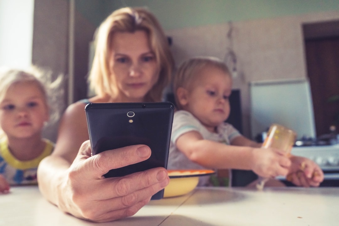 Mother using a smartphone with her kids, evoking the Clementine AI shopping assistant planning family dinner