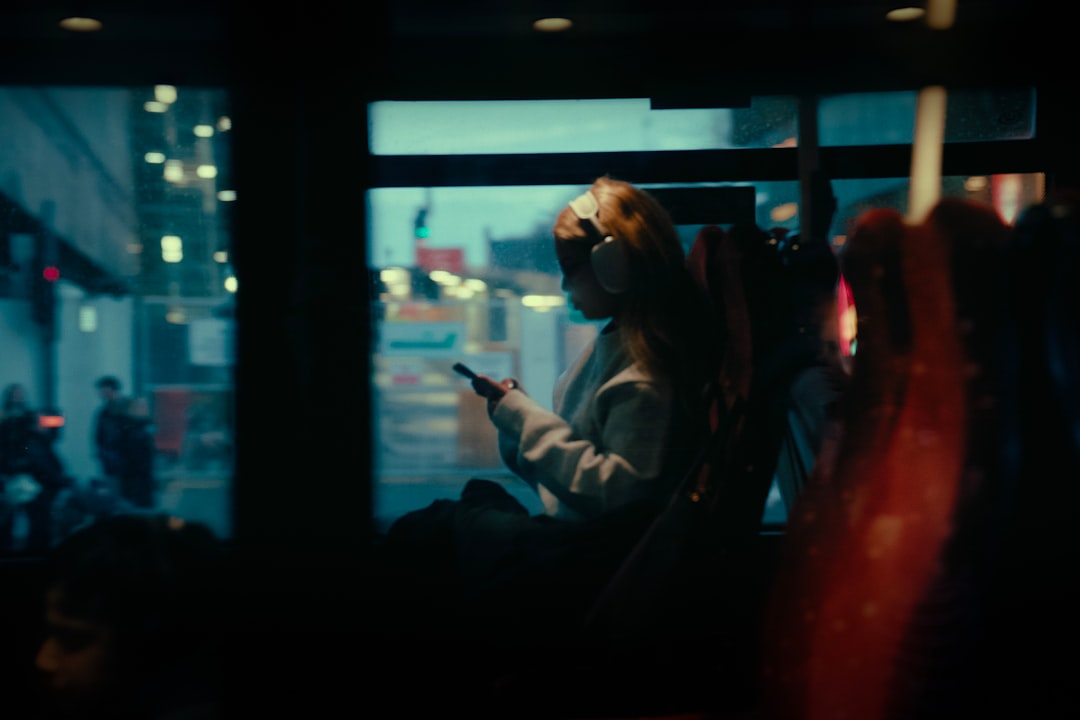 Rider checks a phone for NJ Transit bus tracking and real-time arrival updates on a public bus