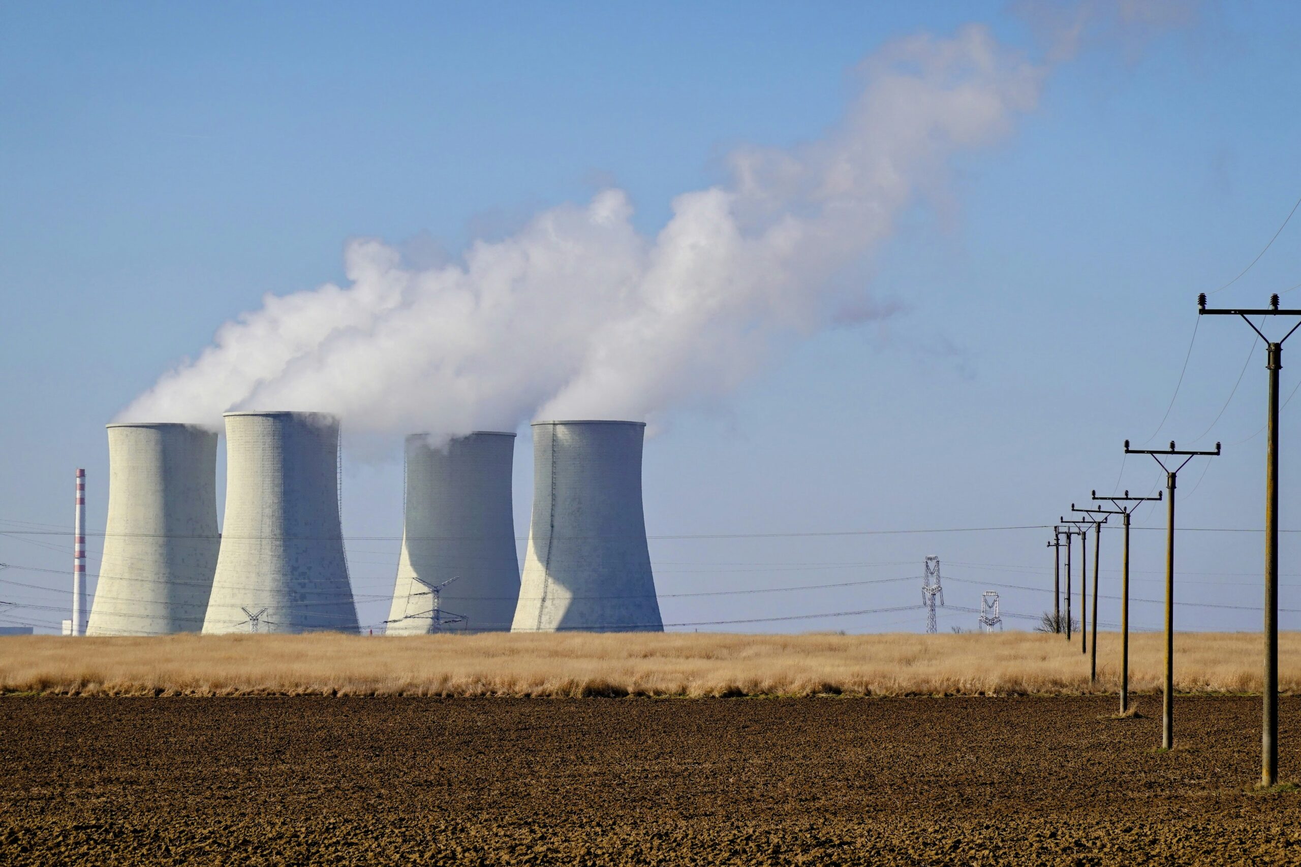 Nuclear plant cooling towers releasing steam, symbolizing the Natrium reactor supply chain