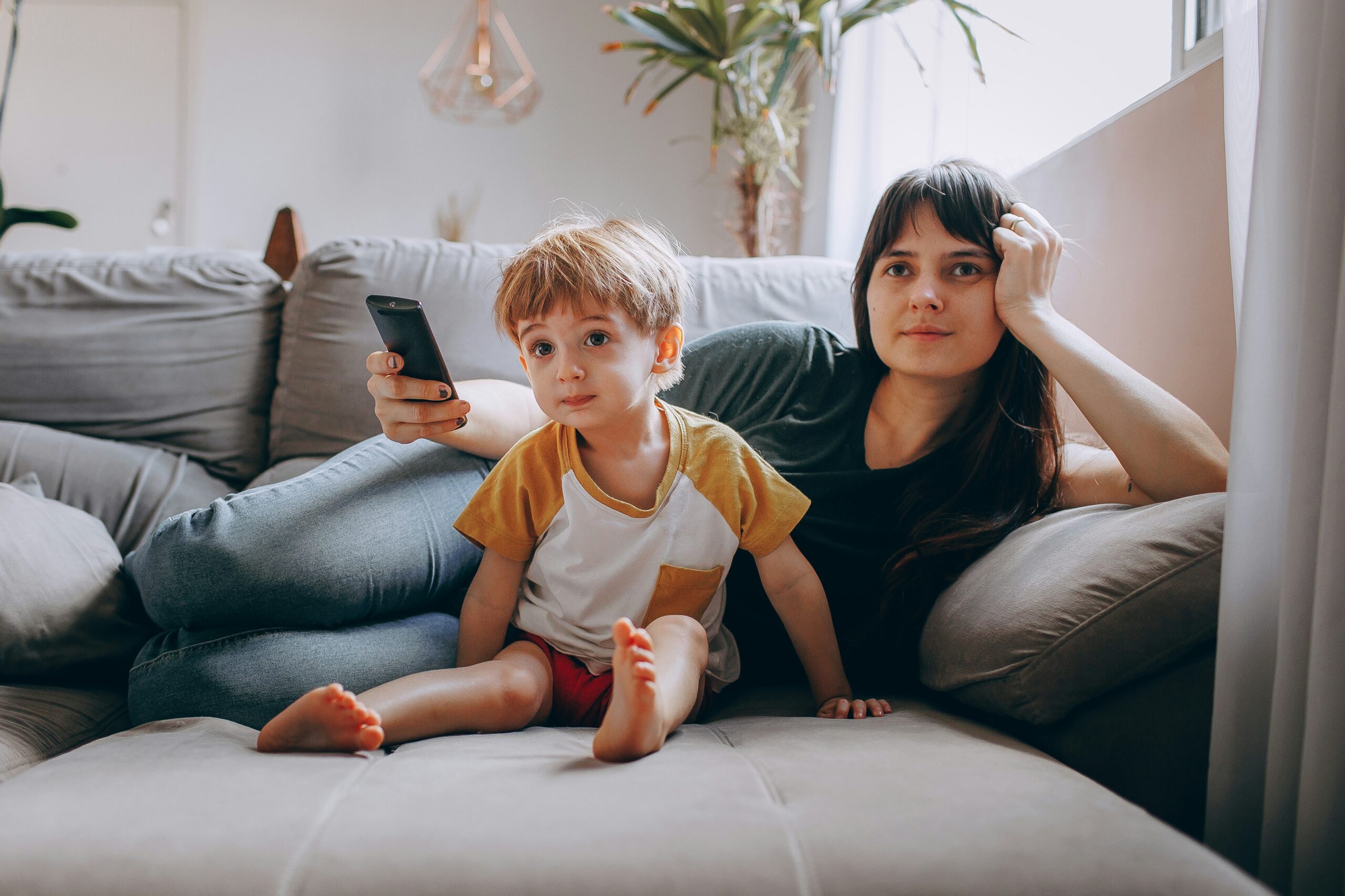 Parent and child looking at a phone together, symbolizing AI attendance alerts reaching families at home
