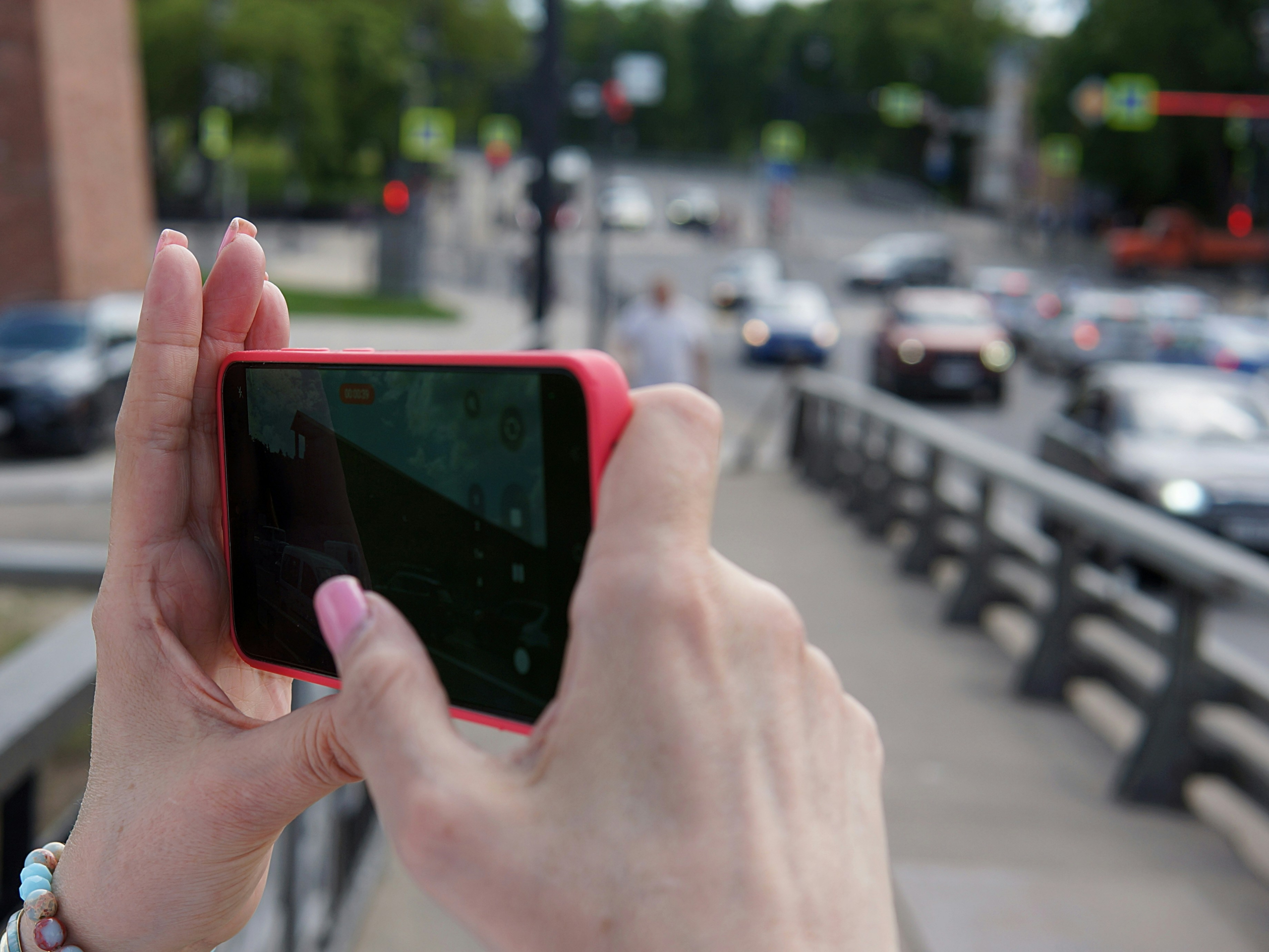 Hand holding a smartphone to report a pothole using the Spring Lake reporting app