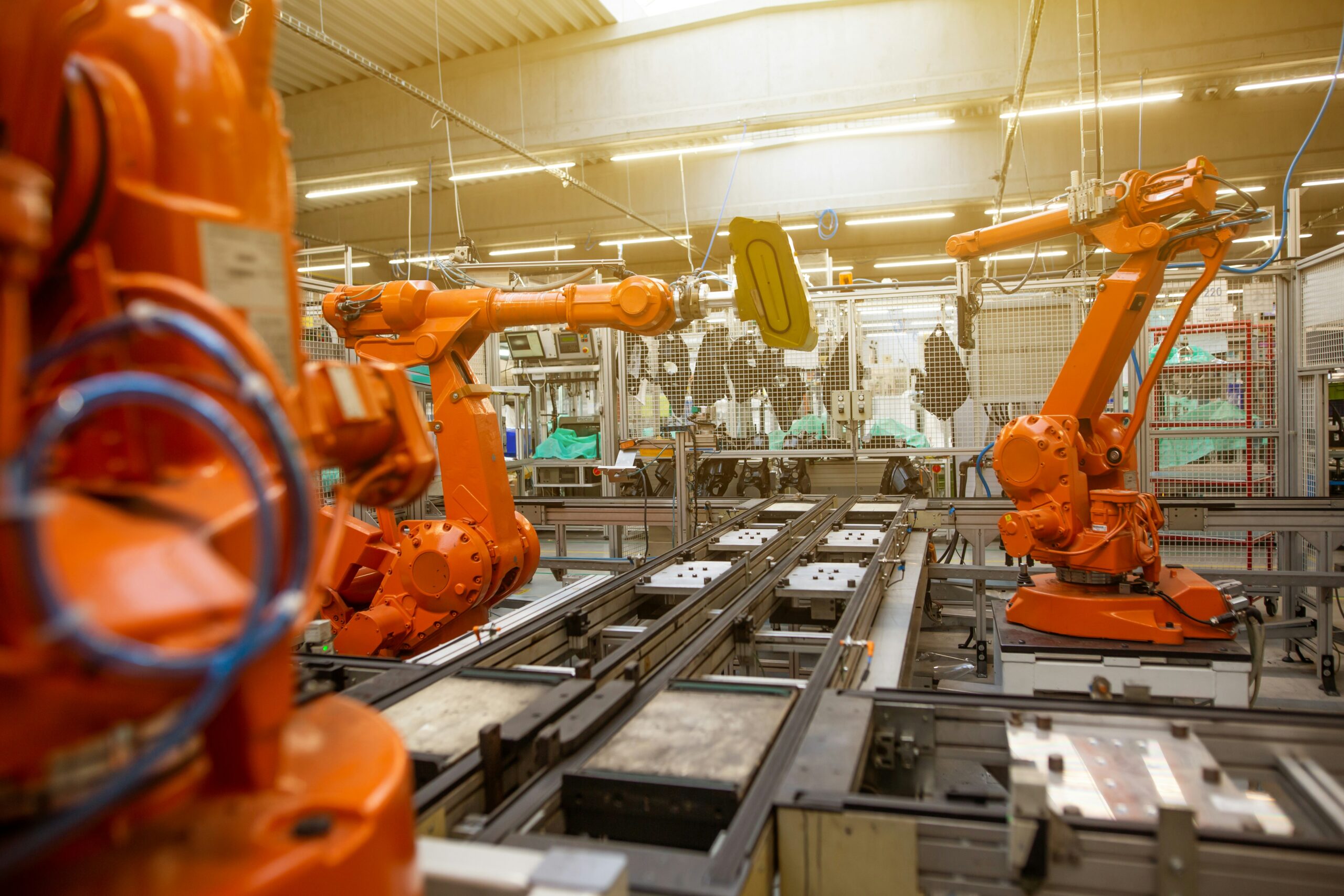 Automated robots in a factory, symbolizing the Rolls-Royce SMR automation deal for factory-built reactors