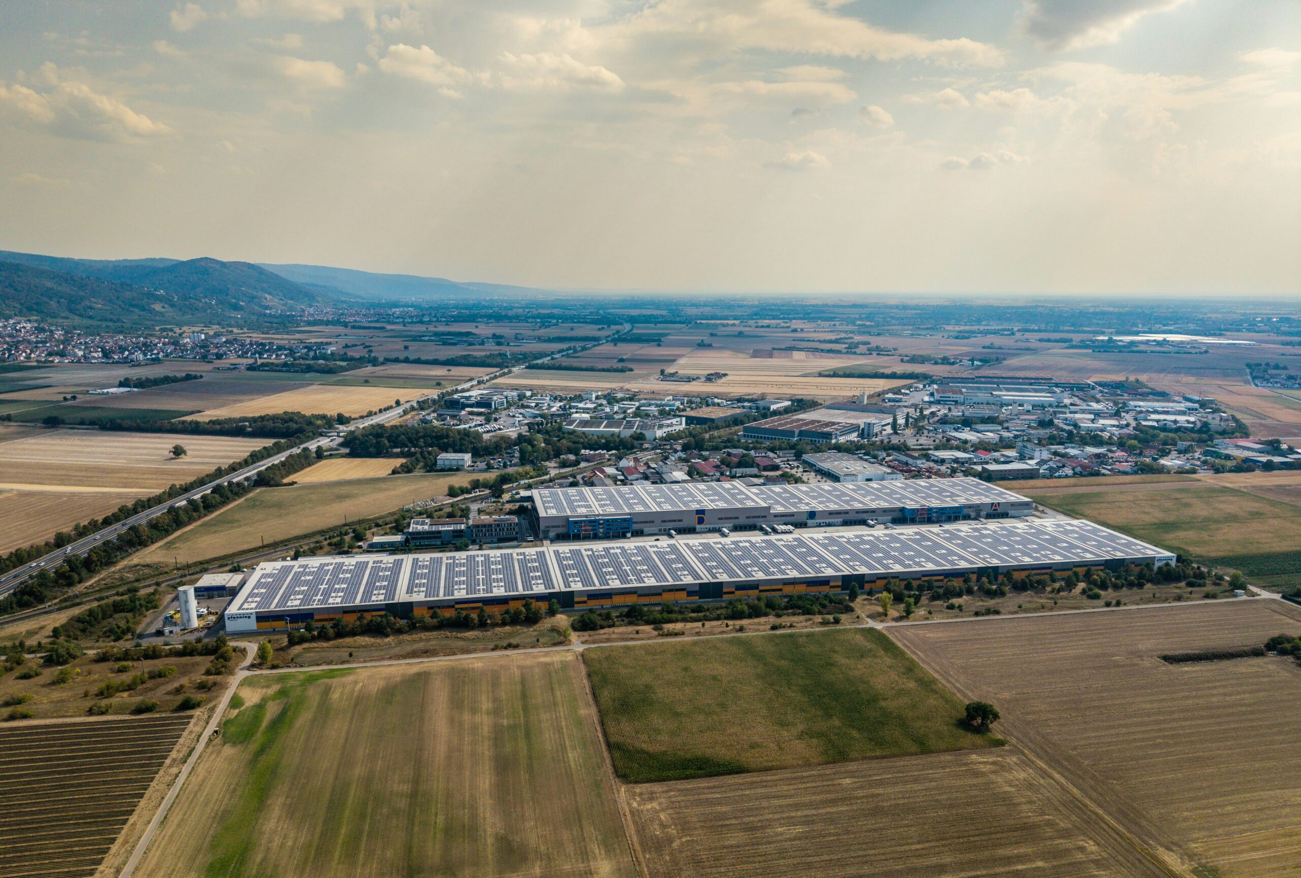 Rooftop solar panels on a large building, showing the clean energy behind rising school solar savings