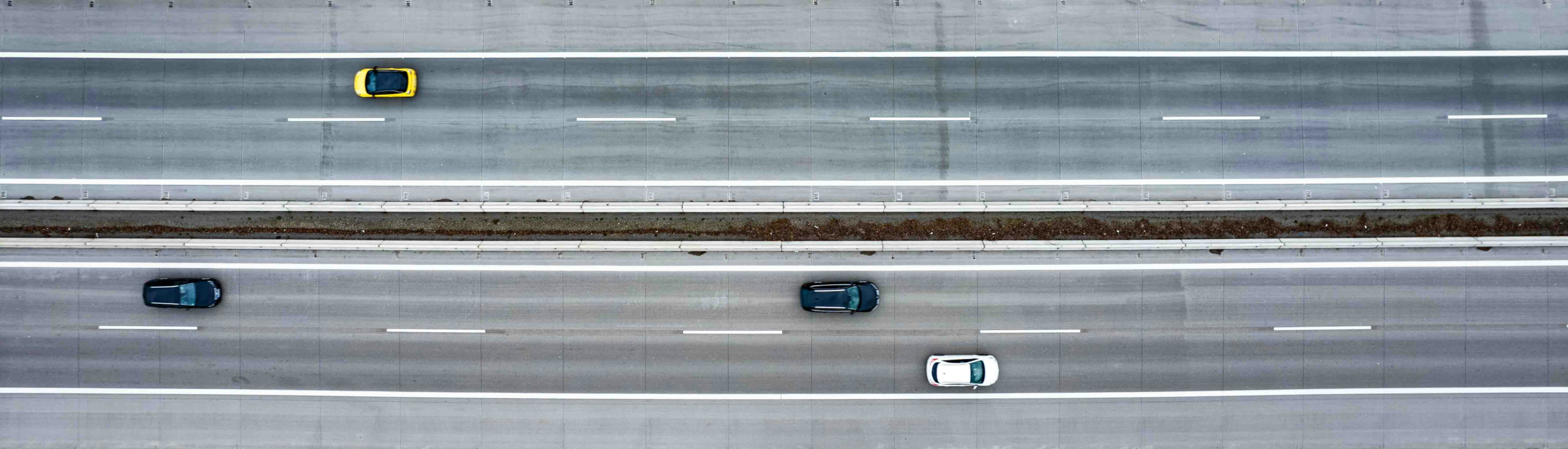 Highway traffic keeping consistent lanes and spacing, illustrating the new self-driving safety standards