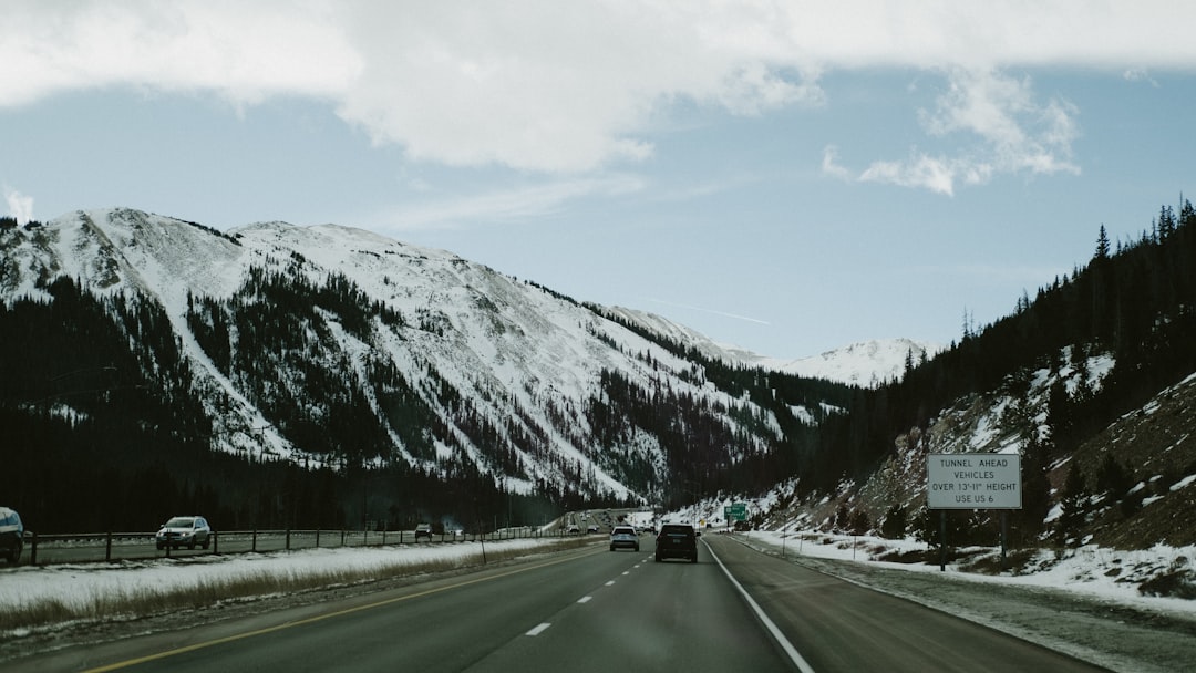Car on a snowy mountain interstate, the type of highway the Connecting the West safety network protects