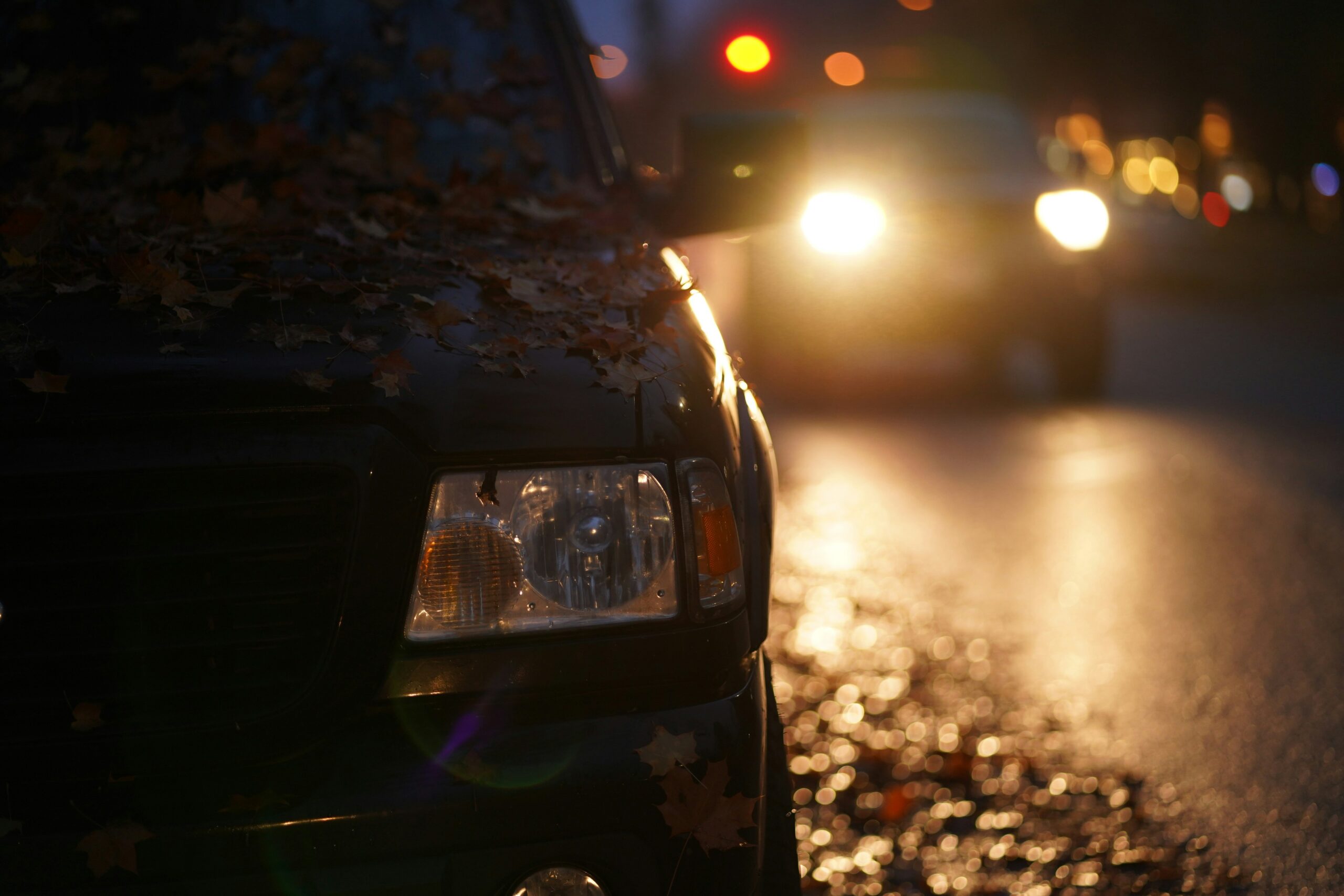 Volvo Connected Safety alert scenario: car headlights illuminating a road hazard ahead at dusk