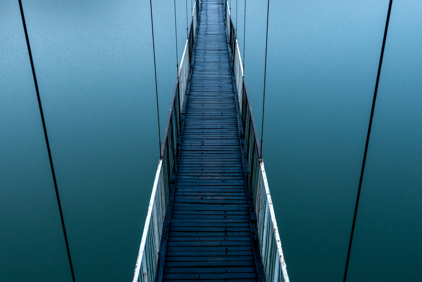 An empty road bridge crossing a wide body of water