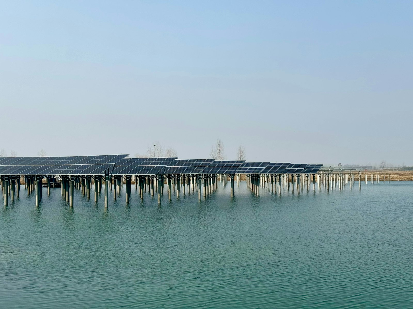 Rows of floating solar panels sitting on a body of water, similar to the array on the Monroeville, Ohio reservoir