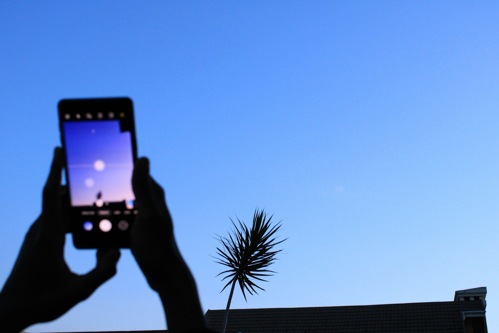 A person holds up a mobile phone on a street in Nairobi, Kenya