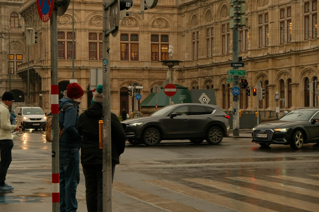 Pedestrians and cars share a city intersection, illustrating Waymo safety data on reduced crash risk