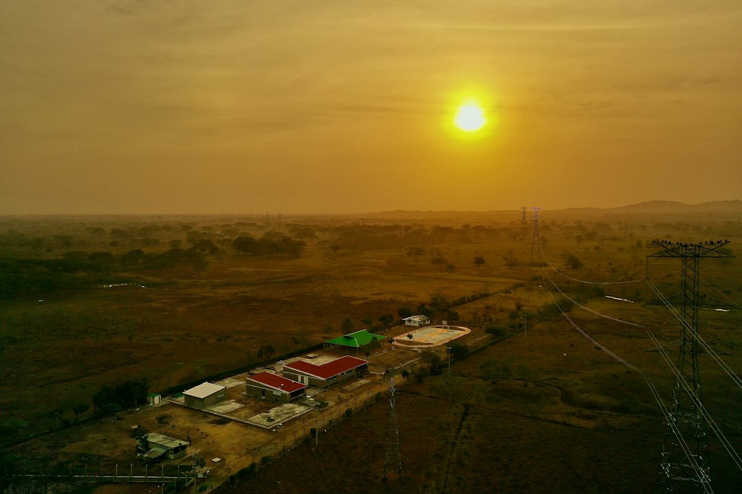 Golden sunset over a rural landscape of homes, representing Central Georgia EMC's new whole-home battery backup program