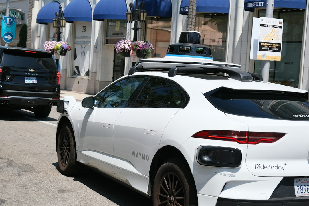 White Waymo self-driving car with roof sensors, as Waymo opens to everyone in San Antonio